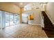 Bright living room with a staircase and sliding glass doors that lead to the pool at 2225 Kettle Dr, Orlando, FL 32835