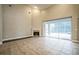 Bright living room with a fireplace and sliding doors that lead to a screened-in lanai at 2225 Kettle Dr, Orlando, FL 32835