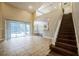 Spacious living room with a staircase and sliding glass doors that lead to the pool at 2225 Kettle Dr, Orlando, FL 32835