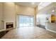 Spacious living room featuring a fireplace, tile flooring, and a view of the backyard pool at 2225 Kettle Dr, Orlando, FL 32835