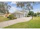 View of the home's rear exterior featuring an attached garage and basketball hoop at 2225 Kettle Dr, Orlando, FL 32835