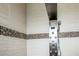 Modern shower features a multi-jet shower panel and beautiful tile design at 2225 Kettle Dr, Orlando, FL 32835