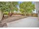 Large backyard with patio, mature trees, and wooden fence at 2267 Santa Lucia St, Kissimmee, FL 34743