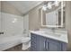Updated bathroom with gray vanity, white subway tile, and a large mirror at 2267 Santa Lucia St, Kissimmee, FL 34743