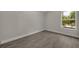 Spacious bedroom with wood-look floors and large window at 2267 Santa Lucia St, Kissimmee, FL 34743