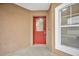 Red front door with a glass panel and a white frame at 2267 Santa Lucia St, Kissimmee, FL 34743