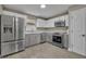 Modern kitchen features stainless steel appliances and gray cabinets at 2267 Santa Lucia St, Kissimmee, FL 34743