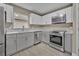 Updated kitchen with stainless steel appliances and light gray cabinets at 2267 Santa Lucia St, Kissimmee, FL 34743