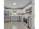 Modern kitchen with grey and white cabinets and stainless steel appliances at 2267 Santa Lucia St, Kissimmee, FL 34743