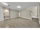 Living room with grey wood-like tile floors and staircase at 2267 Santa Lucia St, Kissimmee, FL 34743