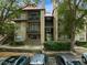 Two-story building with balconies, stairs, and landscaping; cars parked nearby at 234 Afton Sq # 205, Altamonte Springs, FL 32714