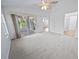 Bright bedroom with carpeted floor and access to a sunroom at 26030 Newcombe Cir, Leesburg, FL 34748