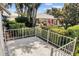 Private patio with metal railing overlooking a lush backyard at 26030 Newcombe Cir, Leesburg, FL 34748