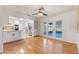 Kitchen and dining area with hardwood floors and white cabinets at 274 W Kings Hwy, Center Hill, FL 33514