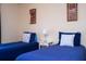 Two twin beds with blue bedding and decor at 3045 Beach Palm Ave, Kissimmee, FL 34747