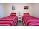 Bedroom with two twin beds and red striped bedding at 3045 Beach Palm Ave, Kissimmee, FL 34747