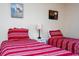 Two twin beds with red striped bedding at 3045 Beach Palm Ave, Kissimmee, FL 34747
