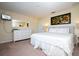 Spacious bedroom with a king-size bed, dresser, and large artwork at 3045 Beach Palm Ave, Kissimmee, FL 34747
