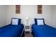 Cozy bedroom with twin-size beds, nightstands and wall art at 3045 Beach Palm Ave, Kissimmee, FL 34747