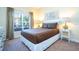 Cozy bedroom with a double bed and large window at 3045 Beach Palm Ave, Kissimmee, FL 34747