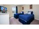 Bedroom with two twin beds, nightstand, and TV at 3045 Beach Palm Ave, Kissimmee, FL 34747