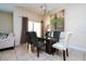 Elegant dining room with glass table and seating for six at 3045 Beach Palm Ave, Kissimmee, FL 34747