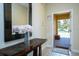 Inviting entryway with decorative console table and mirror at 3045 Beach Palm Ave, Kissimmee, FL 34747