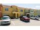 Townhouse exterior with parking and landscaping at 3045 Beach Palm Ave, Kissimmee, FL 34747