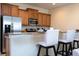 Modern kitchen with stainless steel appliances and breakfast bar at 3045 Beach Palm Ave, Kissimmee, FL 34747