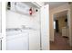 Convenient laundry room with washer, dryer, and shelving at 3045 Beach Palm Ave, Kissimmee, FL 34747