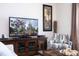 Living room featuring a large TV and comfortable seating at 3045 Beach Palm Ave, Kissimmee, FL 34747