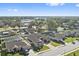 Aerial view of houses with a street and neighborhood at 310 Lake Mariana Pl, Auburndale, FL 33823