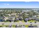 Aerial view of houses with a street and neighborhood at 310 Lake Mariana Pl, Auburndale, FL 33823