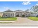 Single-story home with stone accents and a large driveway at 310 Lake Mariana Pl, Auburndale, FL 33823