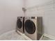Laundry room with matching washer and dryer and overhead shelving at 310 Lake Mariana Pl, Auburndale, FL 33823