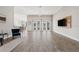 Open living space featuring hardwood floors and a media wall at 310 Lake Mariana Pl, Auburndale, FL 33823