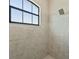 Walk-in shower with tiled walls and a rain shower head at 310 Lake Mariana Pl, Auburndale, FL 33823