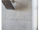 Close up of a shower head in a tiled shower at 310 Lake Mariana Pl, Auburndale, FL 33823