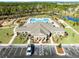 Overhead shot of the community clubhouse, sparkling pool, playground and parking at 3215 Arch Ave, Ormond Beach, FL 32174