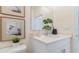 Stylish bathroom with white vanity and framed art at 3215 Arch Ave, Ormond Beach, FL 32174