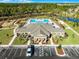 Aerial view of community pool, clubhouse, and surrounding landscape at 3215 Arch Ave, Ormond Beach, FL 32174