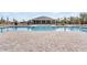 Community pool with lounge seating and clubhouse in the distance at 3215 Arch Ave, Ormond Beach, FL 32174