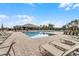 A stunning community pool surrounded by lounge chairs and trees at 3215 Arch Ave, Ormond Beach, FL 32174