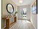Bright and airy foyer with wood-look floors and decorative console table at 3215 Arch Ave, Ormond Beach, FL 32174