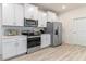Modern kitchen with stainless steel appliances and white cabinetry at 3215 Arch Ave, Ormond Beach, FL 32174