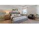 Spacious main bedroom with gray upholstered bed at 3215 Arch Ave, Ormond Beach, FL 32174