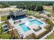 An aerial view of the community pool and clubhouse, with seating and landscaping at 3215 Arch Ave, Ormond Beach, FL 32174