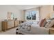 Bedroom with dresser, bed, and large window with natural light at 3221 Arch Ave, Ormond Beach, FL 32174