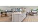 Modern kitchen island with white cabinets and quartz countertop at 3221 Arch Ave, Ormond Beach, FL 32174