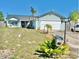 Charming single-story home with a two-car garage, palm trees and a well-maintained lawn at 3250 Dellbrook Dr, Deltona, FL 32738